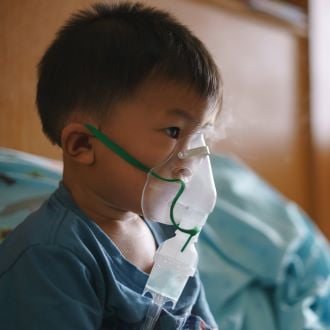 Sick child with oxygen mask