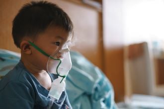 Sick child with oxygen mask