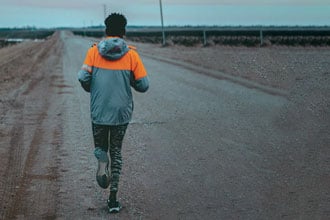 A person out for a run on a dirt road