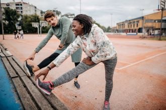 man and woman stretching leg