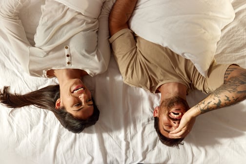 bed-laughing-couple