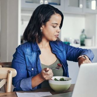 woman eating at her desk